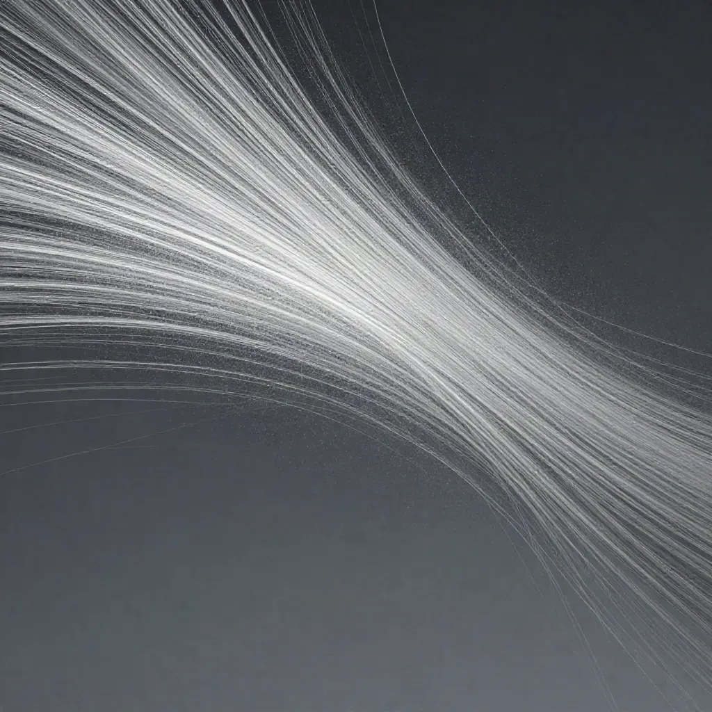 Silver filaments converge into a soft white bloom in dark graphite haze, with open space below.